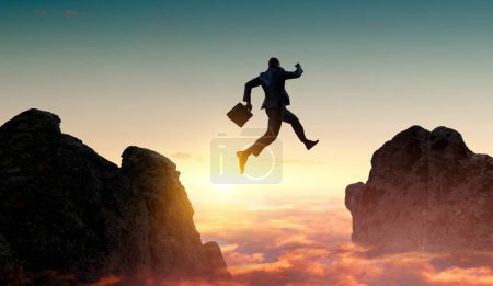 Photo for Businessman jump through the . Business risk and success concept. Mixed media - Royalty Free Image