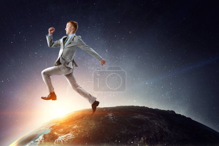 Photo for Portrait of energetic businessman jumping in open air. Mixed media - Royalty Free Image