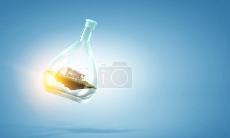 Photo for Environment concept with house inside floating glass bottle. Mixed media - Royalty Free Image
