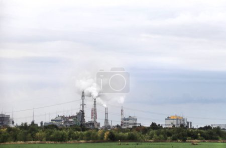 Foto de Air pollution by chimneys of a factory. Chemical industry, smoke smog emissions. Factory emissions pollution. Ecology and global warming  concept - Imagen libre de derechos