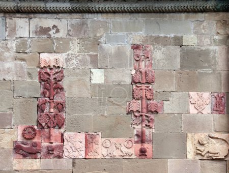 Foto de Wall with stone blocks and medieval clay tiles with decorative ornaments, Svetitskhoveli Orthodox Cathedral, Mtskheta, Georgia. UNESCO world heritage site - Imagen libre de derechos