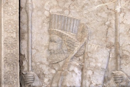 Photo for Ancient wall with bas-relief with assyrian warrior with spear, Persepolis, Iran. UNESCO world heritage site - Royalty Free Image