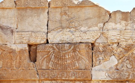 Photo for Ancient wall with bas-relief of Zoroastrian god Faravahar (Frahvahar), Persepolis, Iran. UNESCO world heritage site - Royalty Free Image