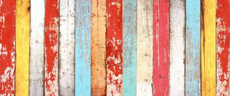 Photo for Texture of vintage wood boards with cracked paint of white, red, orange, yellow, cyan and blue color. Horizontal retro background with old wooden planks of different colors - Royalty Free Image