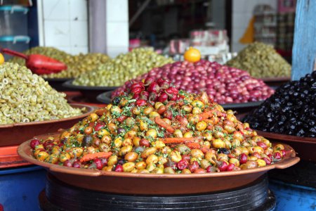 Photo for Piickled olives with spices, hot peppers and carrots on a traditional Moroccan market (souk), Rabat, Morocco - Royalty Free Image