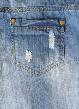 Photo for Ripped jeans pocket of indigo color. Vertical background with denim texture of blue color and pocket - Royalty Free Image