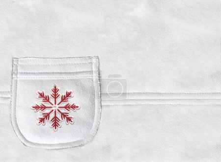 Photo for Horizontal Christmas backdrop with pocket on suede texture of ivory color. Xmas background with suede pocket of light beige color and felt red snowflake. Copy space for text - Royalty Free Image