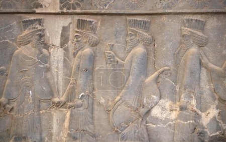 Photo for Ancient wall with bas-relief with assyrian foreign ambassadors with gifts and donations, Persepolis, Iran. UNESCO world heritage site - Royalty Free Image