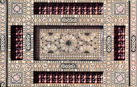 Photo for Detail of ancient mosaic window shutter with mother-of-pearl and wood ornaments. Horizontal or vertical background with traditional moroccan tile decoration - Royalty Free Image