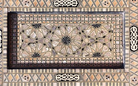 Photo for Detail of ancient mosaic window shutter with mother-of-pearl ornaments. Horizontal or vertical background with traditional moroccan tile decoration - Royalty Free Image