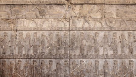 Photo for Ancient wall with bas-relief with assyrian warriors with spears,  horses, chariots, Persepolis, Iran - Royalty Free Image