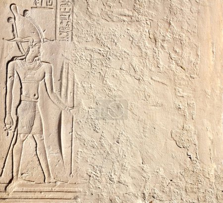 Photo for Horizontal background with ancient Egyptian bas-relief - figure of the pharaoh  on stone wall, Egypt, Africa. Backdrop with sandstone carving with hieroglyph. Mock up template. Copy space for text - Royalty Free Image