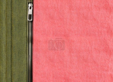Photo for Dark green and pink denim background with zipper. Khaki and coral color denim jeans fabric texture and close zip. Copy space for text - Royalty Free Image