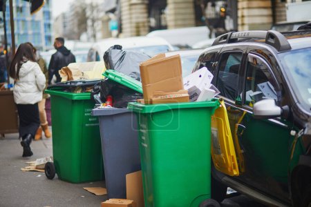 Photo for Paris, France - March 12, 2023: Messy streets with overfull garbage bins during binmen strike in Paris, France - Royalty Free Image