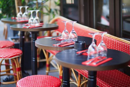 Photo for Wine glasses on a table of cozy Parisian outdoor cafe - Royalty Free Image