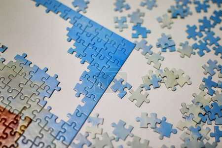 Photo for Connecting jigsaw puzzle pieces, fun family activity - Royalty Free Image