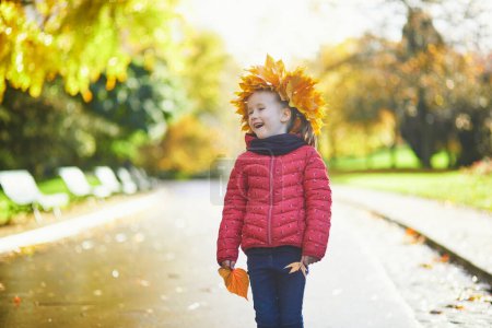 Photo for Adorable preschooler girl enjoying nice and sunny autumn day outdoors. Happy child walking on a fall day in Paris, France. Outdoor fall activities for kids - Royalty Free Image