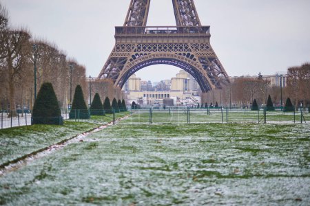 Photo for Scenic view to the Eiffel tower on a snowy day. Thin layer of snow on the ground - Royalty Free Image