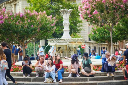 Photo for PARIS, FRANCE - JULY 14, 2023: People sitting by the fountain on Francois 1er square in Paris, France - Royalty Free Image