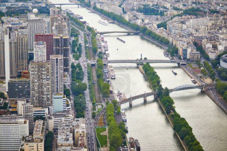 Aerial scenic view of the river Seine with Bir-Hakeim bridge with subway trains on it and touristic boats in Paris, France
