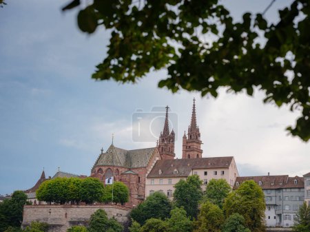 Photo for Buildings in the city centre of Basel , Switzerland. Basel Cathedral is Gothic Protestant cathedral with two spiers and tiled roof, dating back to temple of 9th century. - Royalty Free Image