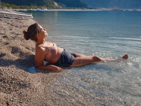 Photo for Cheerful woman enjoying the beach Oludeniz Blue Lagoon Turkey. Life of people xl size, happy nice natural beauty woman - Royalty Free Image