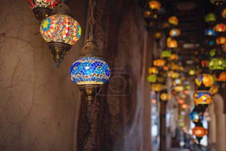 Old historic district in Dubai. Oriental Arabic Colorful glass pendant lamps in Colorful Arabic shop souvenir.