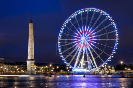 Photo for Beautiful view of night Paris. Ancient Luxor Obelisk and Big Wheel at Place de la Concorde in the late evening. Paris, France - Royalty Free Image