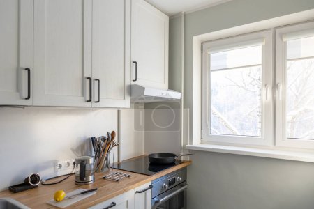 Photo for Modern small light kitchen interior in daylight - Royalty Free Image