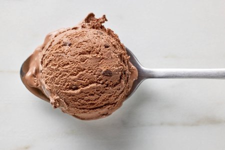 Photo for Chocolate ice cream ball in a spoon, top view - Royalty Free Image