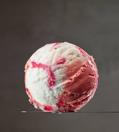 Photo for Vanilla and strawberry ice cream ball on dark grey background - Royalty Free Image