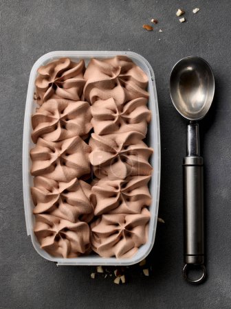 Téléchargez les photos : Open chocolate ice cream package on grey table, top view - en image libre de droit