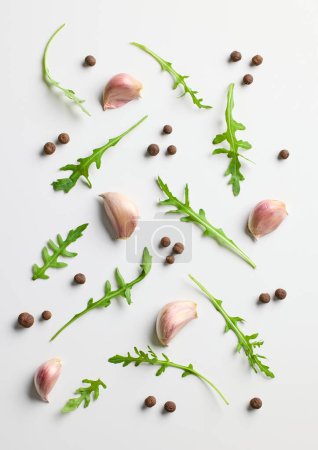 Photo for Composition of garlic, rucola and pepper on white background, top view - Royalty Free Image