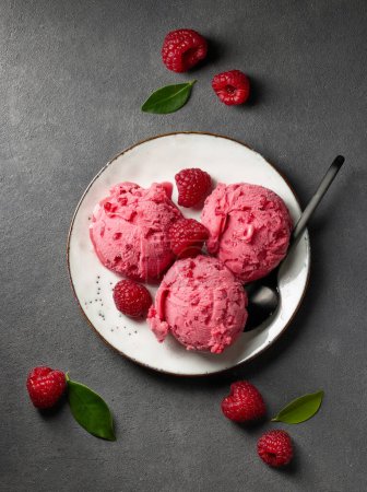 Photo for Plate of raspberry sorbet on dark grey table, top view - Royalty Free Image