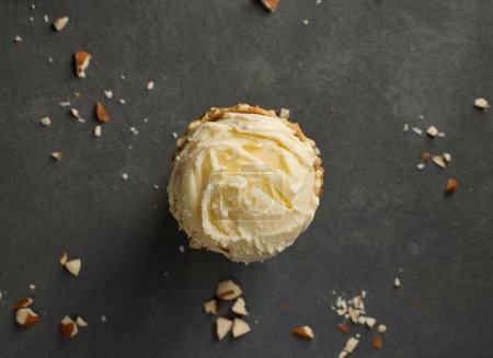 Foto de Vanilla ice cream ball in waffle cone on dark grey table background, top view - Imagen libre de derechos