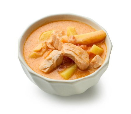 Foto de Bowl of salmon and tomato soup with potatoes isolated on white background - Imagen libre de derechos