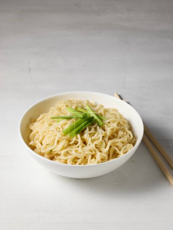 Photo for Bowl of boiled noodles and chopsticks on white table - Royalty Free Image