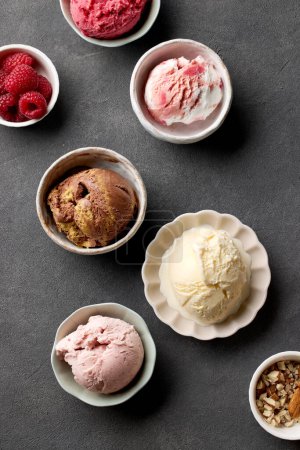 Photo for Bowls of various ice creams on grey table, top view - Royalty Free Image