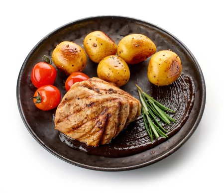 Photo for Plate of freshly grilled pork fillet steak with potatoes isolated on white background - Royalty Free Image