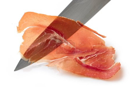 Photo for Sliced spanish iberico ham and knife isolated on white background - Royalty Free Image