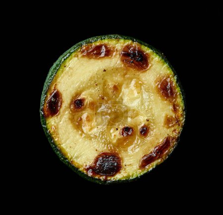 Photo for Grilled juicy zucchini slice isolated on black background, top view - Royalty Free Image