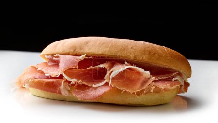 Photo for Sandwich with sliced spanish iberico ham isolated on black and white background - Royalty Free Image