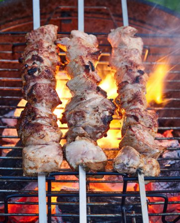 Photo for Grilled marinated pork meat skewers on charcoal grill, selective focus - Royalty Free Image