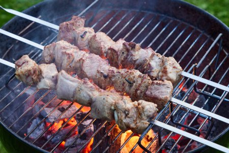Photo for Grilled marinated pork meat skewers on charcoal grill, selective focus - Royalty Free Image