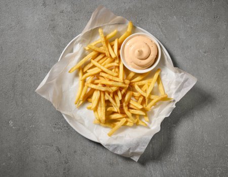Photo for Plate of french fries and dip mayonnaise sauce on grey table, top view - Royalty Free Image