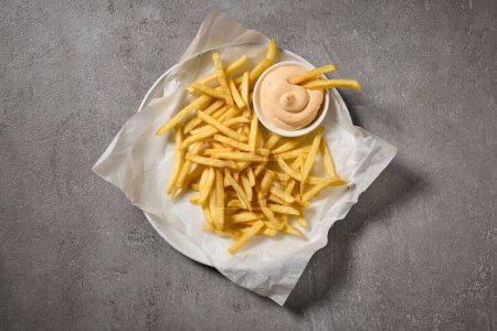 Foto de Papas fritas con salsa de mayonesa en la mesa gris, vista superior - Imagen libre de derechos