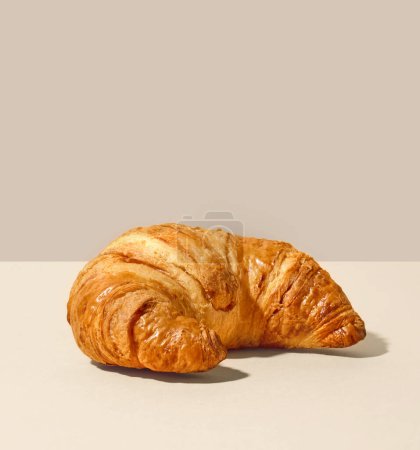 Photo for Freshly baked butter croissant on beige background - Royalty Free Image