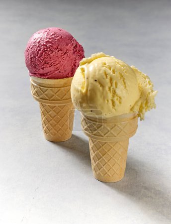 Photo for Vanilla and berry ice cream in waffle cones - Royalty Free Image
