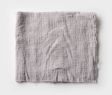 Foto de Servilleta de algodón gris doblada sobre fondo blanco, vista superior - Imagen libre de derechos