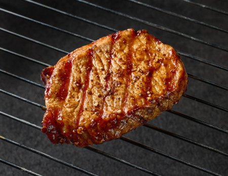 Photo for Freshly grilled juicy steak closeup on black background - Royalty Free Image